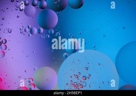 Abstract colorful Background, purple Bubbles and circles in oily Water. Blue and pink colors. Macro photography. Top view. Stock Photo