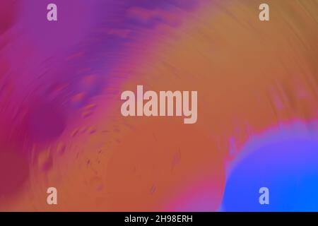 Blurred background in circular shape with blue, purple and orange colors. Macro photography. Top view. Stock Photo