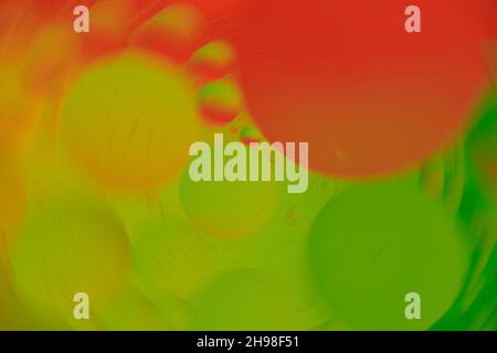 Blurred background in circular shape with bubbles, red, green and yellow colors. Macro photography. Top view. Stock Photo