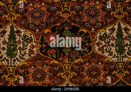 Patterns with cypresses, flowers and birds in black and white curly, alternating cells on a burgundy background  in the style of "Auchan" on an ancien Stock Photo
