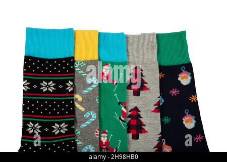 Multi-colored socks on a white background. View from above. Many different socks for cold seasons. Socks are scattered on a bright background. Socks o Stock Photo