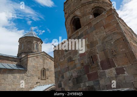 Separated belltower and the church itself,of the Gergeti Trinity Church ( Tsminda Sameba) on a hilltop near Tsepantsminda, Georgia, Caucasus Stock Photo