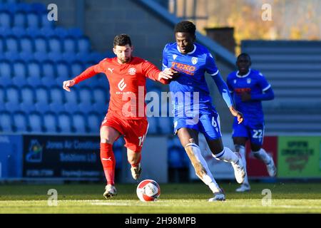 COLCHESTER, GBR. DEC 5TH Brendan Sarpong-Wiredu of Colchester battles for possession with Jordan Jones of Wigan during the FA Cup match between Colchester United and Wigan Athletic at the JobServe Community Stadium, Colchester on Sunday 5th December 2021. (Credit: Ivan Yordanov | MI News) Credit: MI News & Sport /Alamy Live News Stock Photo