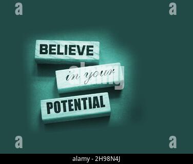 Believe in Your Potential word written on wooden blocks. Motivation for achievements in business or career concept. Stock Photo