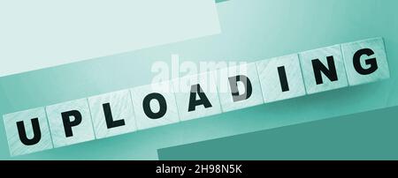 uploading word on wooden cubes. Online downloadable Internet resources concept Stock Photo