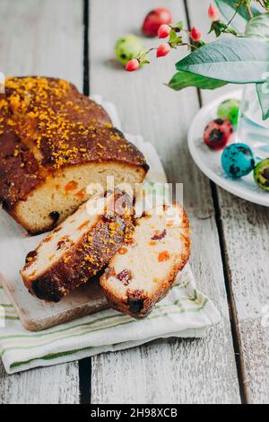 Easter citrus cake with dried fruits for holiday on wooden table background. Copy space, vertical image Stock Photo