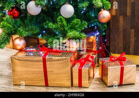 Christmas decoration with gift boxes under the fir tree Stock Photo