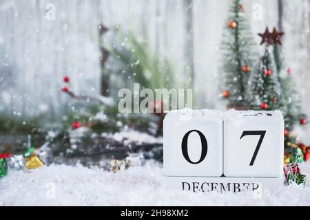 National Pearl Harbor Day of Remembrance. White wood calendar blocks with the date December 7th with snow. Selective focus with blurred background. Stock Photo