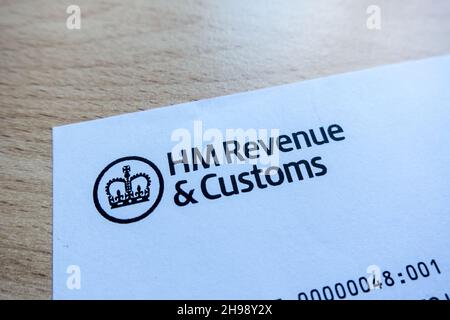 HM Revenue and Customs logo printed on a letter with a table background Stock Photo