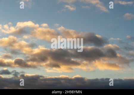 Cloudscape at dusk with gathering cumulus clouds. Stock Photo
