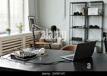 Background image of recording room interior with studio microphone on stand and laptop setup, copy space Stock Photo