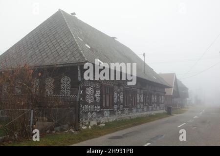 Traditional log houses decorated with white linear patterns in the village of Čičmany in Žilina Region in Slovakia. Stock Photo