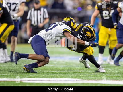 Indianapolis, Indiana, USA. 04th Dec, 2021. Michigan linebacker Nikhai Hill-Green (41) makes the tackle on Iowa running back Tyler Goodson (15) during NCAA Football game action between the Michigan Wolverines and the Iowa Hawkeyes at Lucas Oil Stadium in Indianapolis, Indiana. Michigan defeated Iowa 42-3. John Mersits/CSM/Alamy Live News Stock Photo