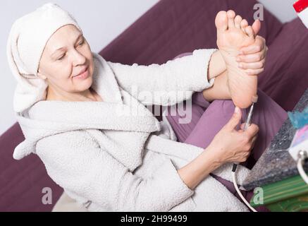 Woman doing pedicure Stock Photo