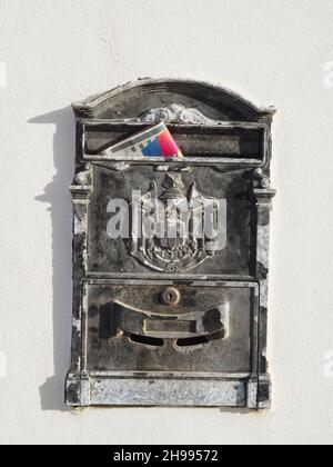Metal old mail box with a newspaper Stock Photo