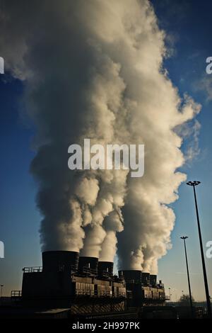 Factory chimneys with smoke emission. Industrial factory pollution, smokestack exhaust gases. factory chimney