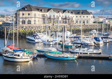Luxury,apartment,apartments,flats,building,overlooking,Boats,yachts,moored,at,Aberystwyth Harbour,Harbor,Marina,in,Aberystwyth,Cardigan Bay,coast,coastline,on,a,sunny,but,windy,December,winter,winters,day,Mid,West,Wales,Ceredigion,Ceredigion County,Welsh,GB,UK,United Kingdom,Great Britain,Britain,British,Europe,European, Stock Photo