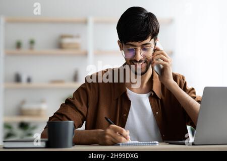 Smiling successful middle eastern man talking on phone Stock Photo