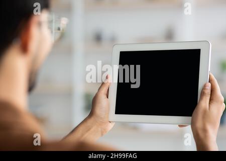 Unrecognizable young man holding digital tablet, mockup Stock Photo