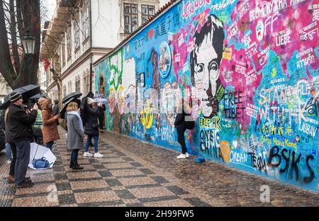 Prague, March 11, 2020: People take a photo at the John Lennon wall in Prague Stock Photo