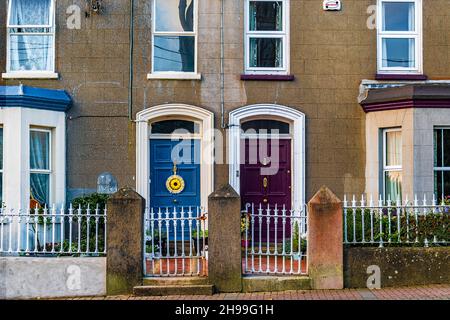 Traditional Irish blue and violet neighbouring doors in Georgian style building in Arklow. Stock Photo