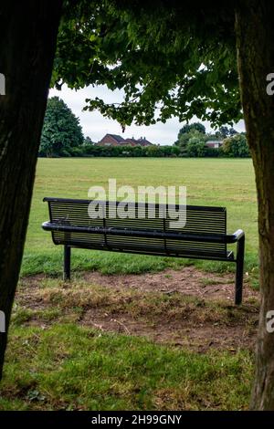 Metal Park bench from the rear in Greenlands Park, Dinnington, South Yorkshire Stock Photo
