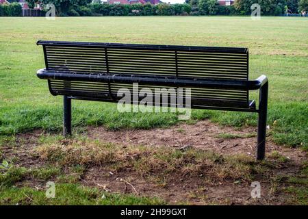 Metal Park bench from the rear in Greenlands Park, Dinnington, South Yorkshire Stock Photo