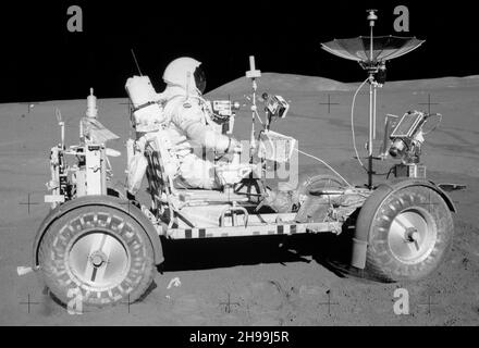 Apollo 15 Commander David Scott drives the lunar roving vehicle on the surface of the Moon, the first time the rover was used. Stock Photo