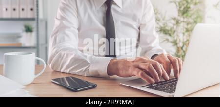Businessman working on e-document on laptop computer in office workspace, panoramic banner with selective focus Stock Photo