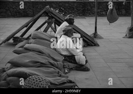 Group of Traditional Arabic fishermen sitting in Katara cultural village in Doha, Qatar monochrome image during Katara  traditional dhow festival Stock Photo