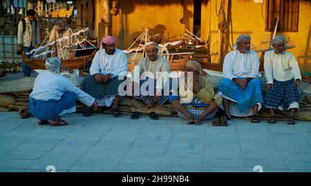 Group of Traditional Arabic fishermen sitting in Katara cultural village in Doha, Qatar daylight view during Katara eleventh traditional dhow festival Stock Photo