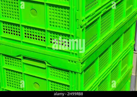Two green plastic crates are placed one on top of the other. Stock Photo