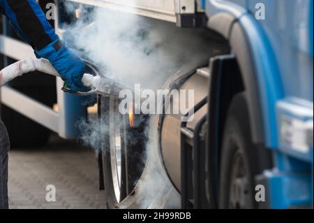 When pulling off the tank gun, some gas escapes Stock Photo