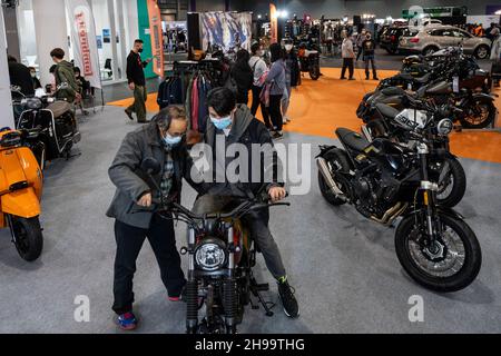 Hong Kong, China. 05th Dec, 2021. Visitors test a motorbike during the International Motor Expo (IMXHK) showcasing thermic and electric cars and motorcycles in Hong Kong. Credit: SOPA Images Limited/Alamy Live News Stock Photo