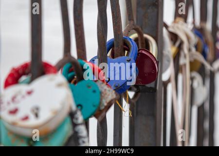 Door locks are hung on the railing of the bridge as a symbol of the wedding. Stock Photo