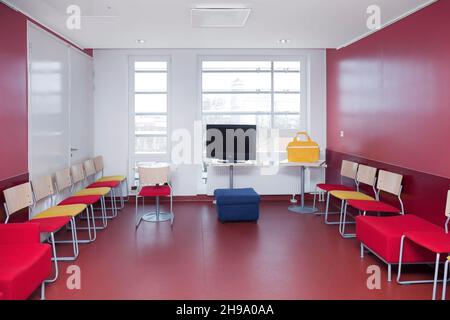 Corridor and waiting areas of a modern hospital with seating Yellow bag. Stock Photo