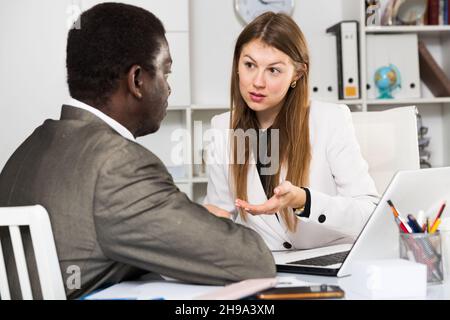 Two colleagues talking in office Stock Photo