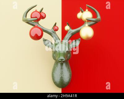 A green deer head on the wall, with Christmas toys on the antlers. Part of the background is yellow, part of the background is red. Festive concept. 3 Stock Photo