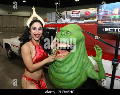 Los Angeles, California, USA. December 3rd, 2021. Sparkle Soojian poses with the character called 'Slimer' and the car from the movie 'Ghostbusters' at L.A. Comicon at the Los Angeles Convention Center in Los Angeles, California.  Credit: Sheri Determan Stock Photo
