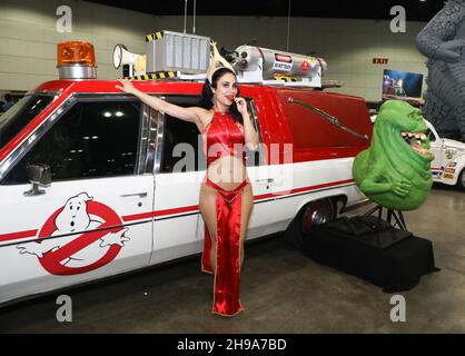Los Angeles, California, USA. December 3rd, 2021. Sparkle Soojian stands next to the car from the movie 'Ghostbusters' at L.A. Comicon at the Los Angeles Convention Center in Los Angeles, California.  Credit: Sheri Determan Stock Photo