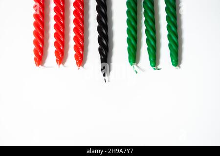 Happy Kwanzaa concept. Afro-American holiday. Seven candles - red, black and green. African heritage symbol on a white background. Stock Photo