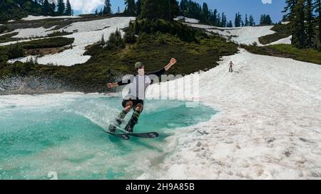 Skier on Melted Snow. Heather Meadows, North Cascades National Park, Washington State, USA Stock Photo