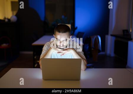 Man content editor or entrepreneur online business owner work at night overtime with distance job Stock Photo