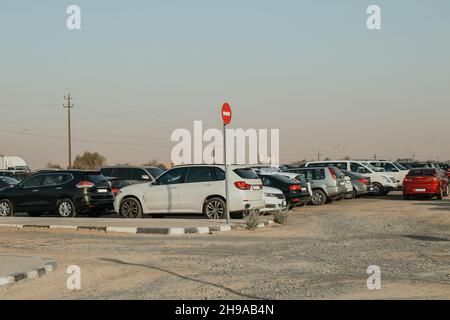 City outdoor not equipped parking for cars on the street with many cars at a daytime Stock Photo