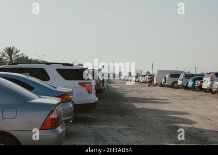 City outdoor not equipped parking for cars on the street with many cars at a daytime Stock Photo