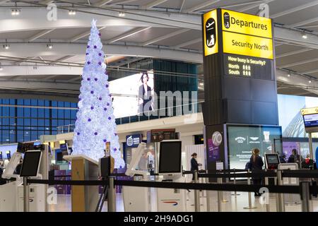 flights Departure halls decorated with Christmas trees at London Heathrow airport terminals amid omicron variant spread in winter travel. England UK Stock Photo