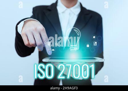 Text showing inspiration Iso 27001. Concept meaning specification for an information security management system Lady In Suit Pointing On Tablet Stock Photo