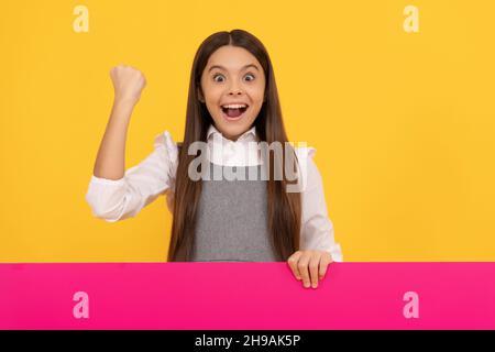 child behind paper sheet. copy space for useful information. place for promotion and creativity. Stock Photo