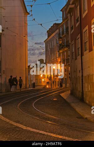 Night view of tram tracks going through cobblestone street in Alfama, one of Lisbon's oldest areas, Lisbon, Portugal Stock Photo