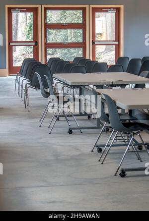Generic meeting room set up for a group, with chairs and tables and lots of space Stock Photo